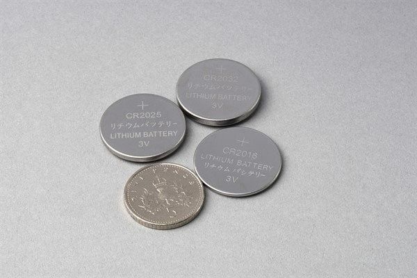 Button batteries size comparison to five pence coin.