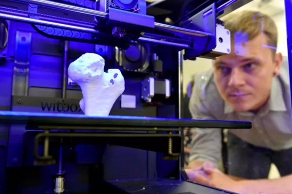 Man and 3D printer