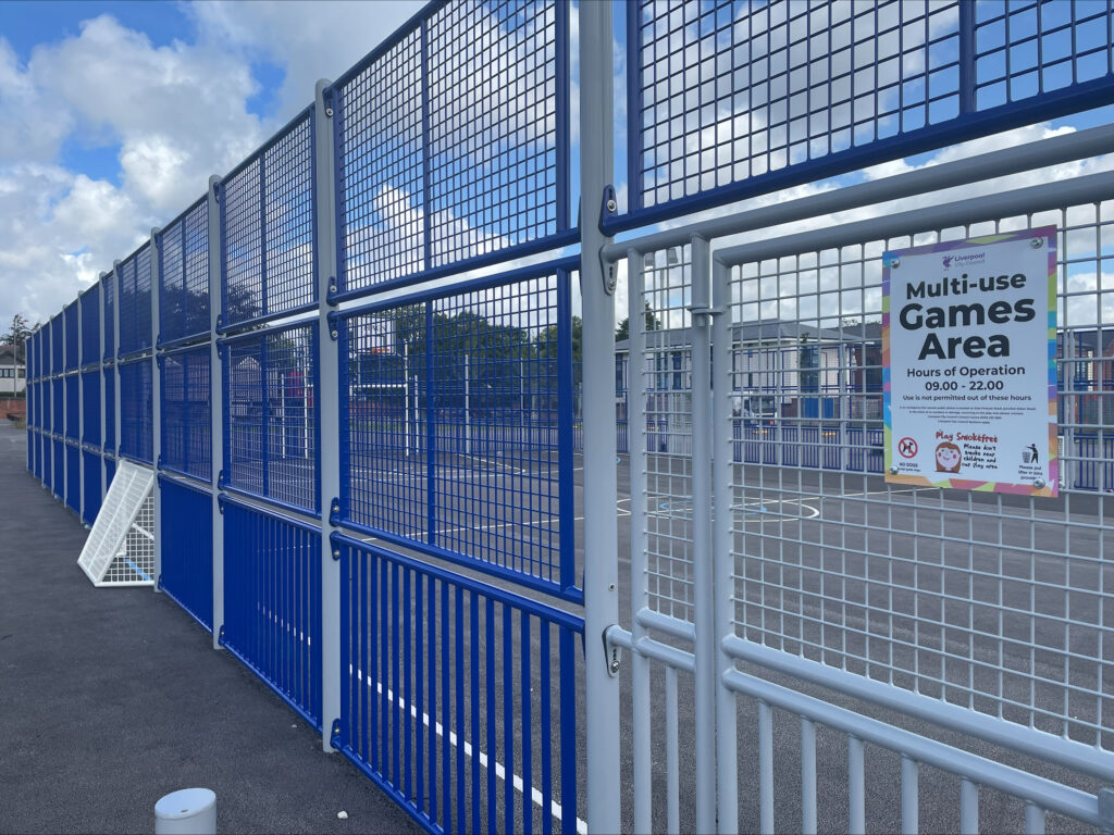 An image of the outside of the multi use games area showing a sign with the operating times of 9am to 10pm on it.