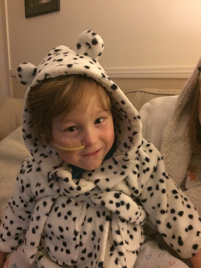 Hayley smiling sitting on mum's lap