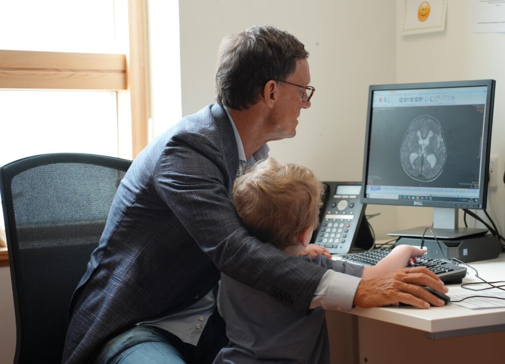 Mr Mallucci showing Conor his brain scan