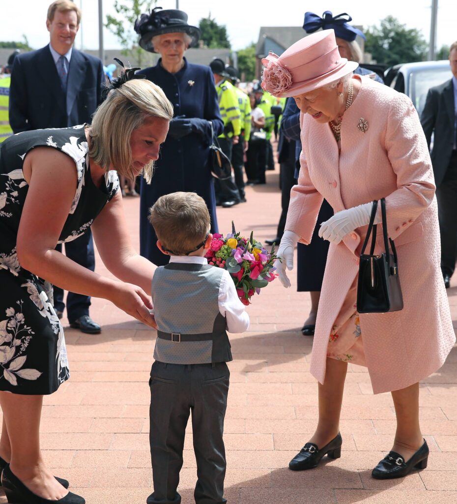 Photo of Lewis Connett giving flowers to Queen Elizabeth II