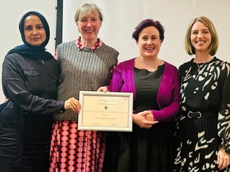 Photo of four people receiving award