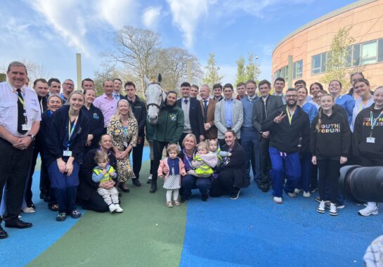 Neptune Collonges, jockeys and Alder Hey staff and children posing for photo