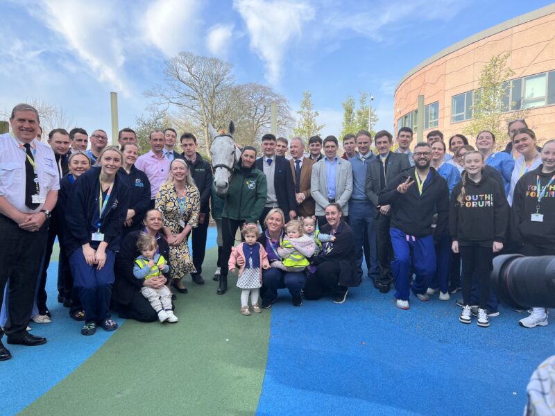Neptune Collonges, jockeys and Alder Hey staff and children posing for photo