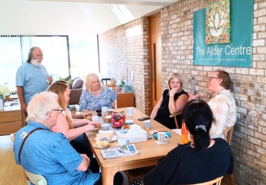 An image of people sitting around a table chatting