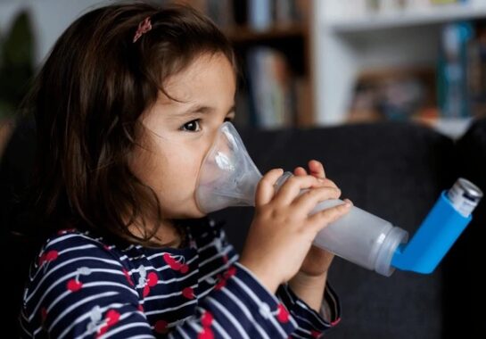 A child holding a nebulizer inhaler.