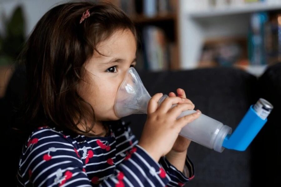 A child holding a nebulizer inhaler.