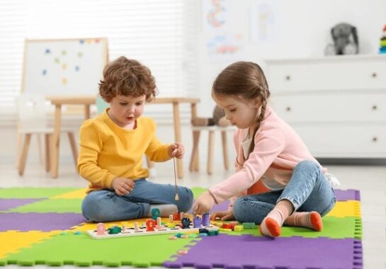 A stock image of young children playing with toys.