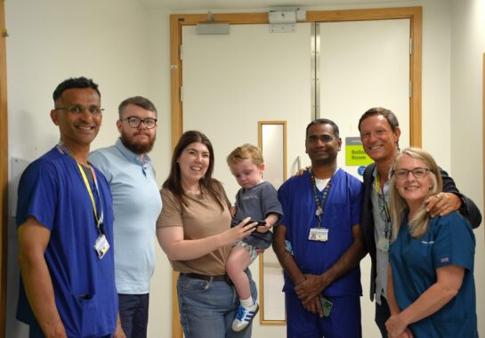 A picture of Conor with his parents and the team that treated him at Alder Hey