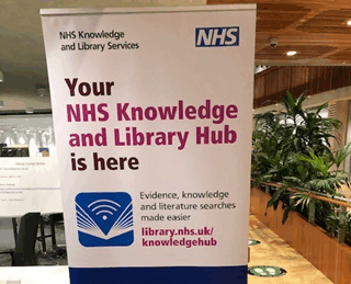 An image of a sign that reads "your NHS Knowledge Library Hub is here"
