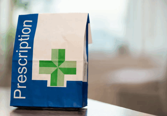 An image showing a prescription bag on a countertop.