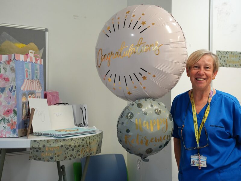 Mary Lamb pictured with a balloon celebrating her retirement at Alder Hey