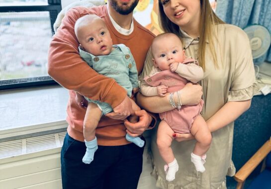 Family photo of parents holding twins