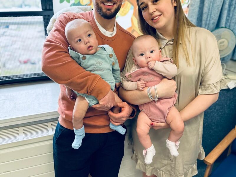 Family photo of parents holding twins