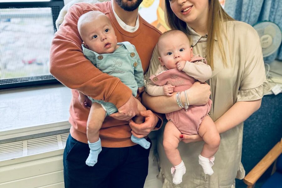 Family photo of parents holding twins