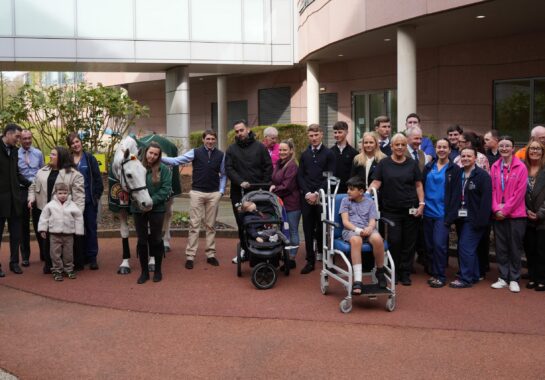 Group shot of the Neptune, staff, jockeys and children