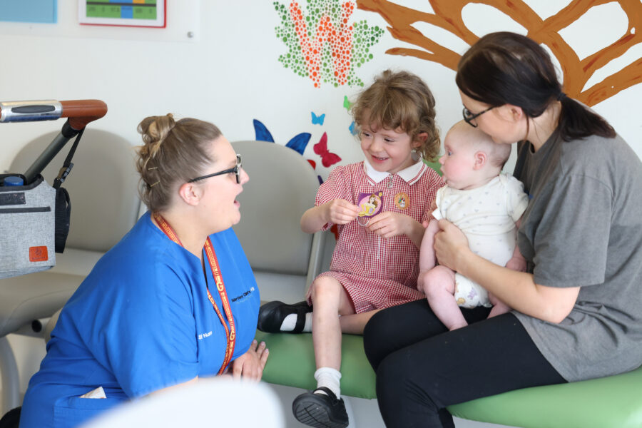Nurse with mum with child and baby