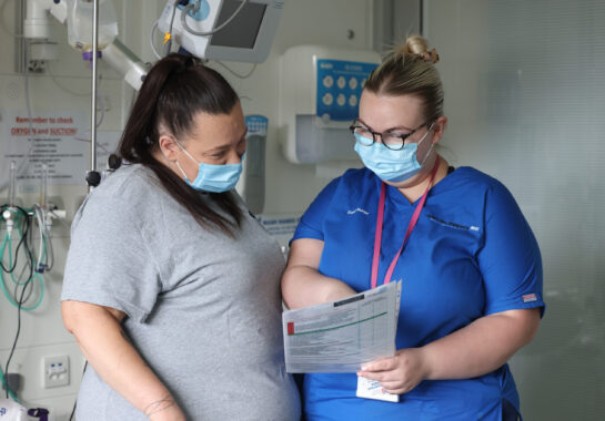 Nurse with parent looking at a form