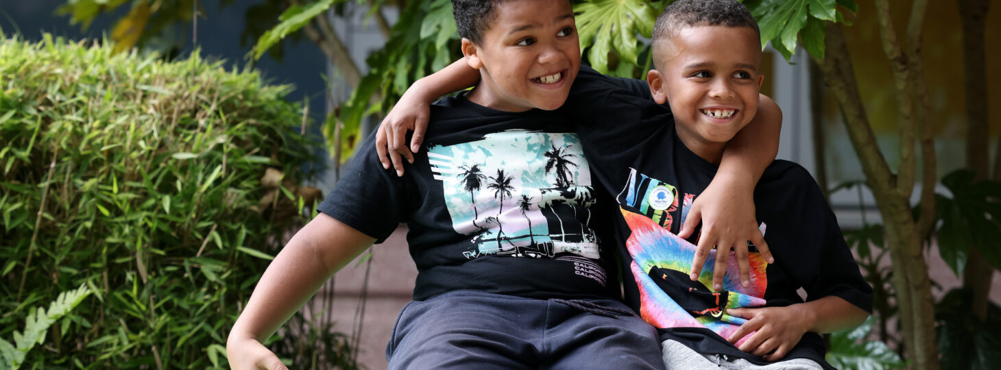 Two children with arms around each other