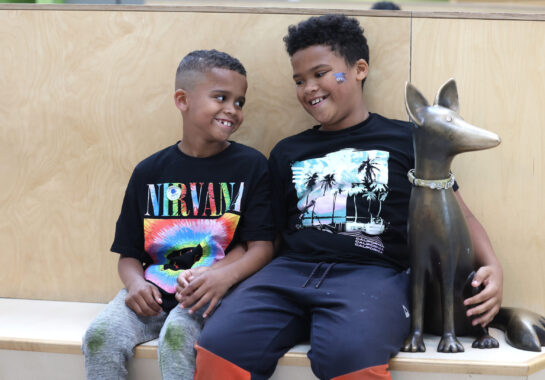 Two boys in atrium next to Sloane