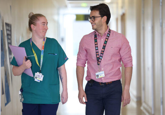 Two clinicians walking down a corridor