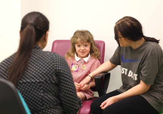 Photo of child and carer at an appointment