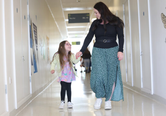 Parent and child walking down corridor